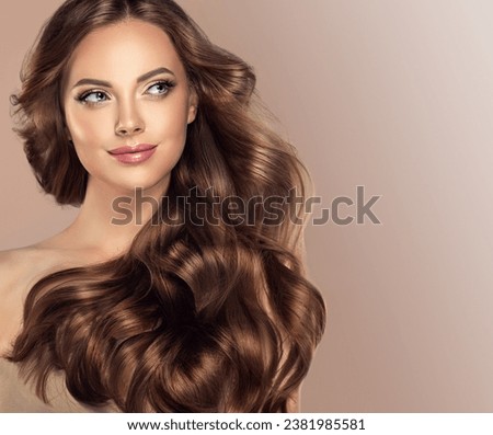 Beauty brunette girl with long  and   shiny wavy black hair .  Beautiful   woman model with curly hairstyle . Cosmetology , beauty  and spa .