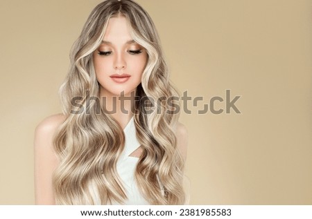 Beautiful girl with hair coloring in ultra blond. Stylish hairstyle curls done in a beauty salon. Fashion, cosmetics and makeup Royalty-Free Stock Photo #2381985583