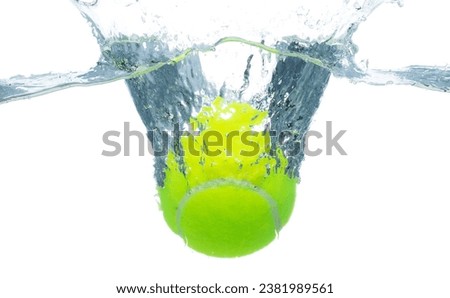 Tennis Ball falls into water and creates air bubbles on surface. Tennis green Ball drop hit smash to clear water and deep to bubble. White background isolated freeze motion Royalty-Free Stock Photo #2381989561