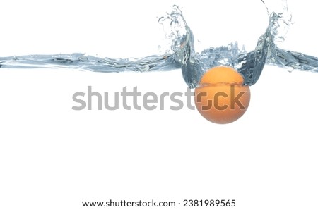 Ping Pong ball falls into water and creates air bubbles on surface. PingPong Table Tennis orange ball drop hit smash to clear water and deep to bubble. White background isolated freeze motion Royalty-Free Stock Photo #2381989565