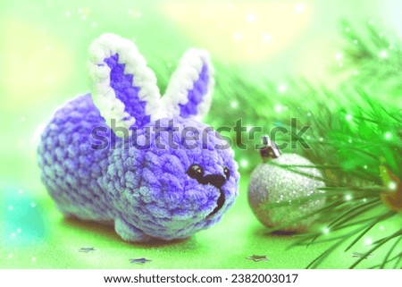 New Year decorations. Golden lights. Christmas card with funny toy bunny. Happy new year