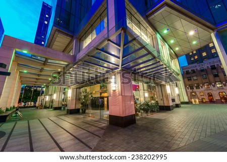 Entrance to the building lobby. Night scene of modern colorful city life with skyscrapers, highrise buildings. Vancouver downtown  at night.