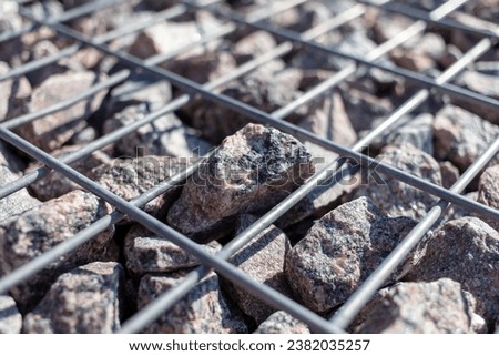 Stones under a metal grate. Background.