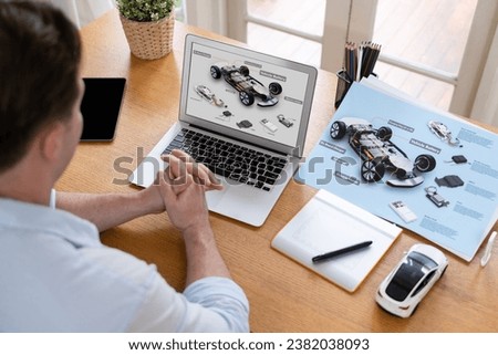 Car design engineer analyze car prototype for automobile business at home office. Automotive engineering designer carefully analyze, finding flaws and improvement for car design with laptop Synchronos Royalty-Free Stock Photo #2382038093