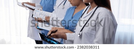 Medical staff team with doctor nurse and healthcare specialist professions working together with laptop and tablet in hospital. Medical workplace and healthcare community in panoramic banner. Neoteric