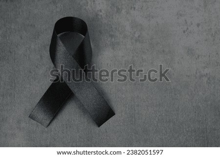 Black satin ribbon isolated on dark background 
