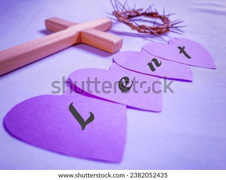 Lent Season, Holy Week, Ash Wednesday and Good Friday concepts - Lent text on heart shaped paper with purple background. Stock photo.
