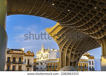 Metropol Parasol wooden structure with Seville city skyline in the old quarter of Seville in Spain at sunset Royalty-Free Stock Photo #2382061515