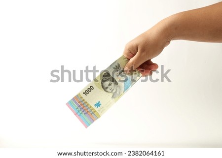 Hand holds all Indonesian currency cash. Indonesian Money. IDR 1000, 2000, 5000, 10000, 20000, 50000, 100000. Raw Photo material.