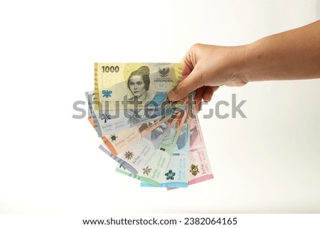 Hand holds all Indonesian currency cash. Indonesian Money. IDR 1000, 2000, 5000, 10000, 20000, 50000, 100000. Raw Photo material.