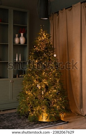 Stylish Christmas tree without toys with lights in Scandinavian style in the interior of the living room of the house