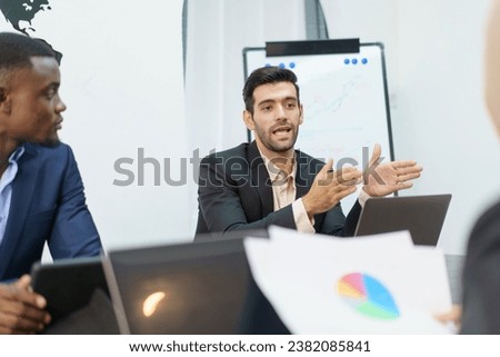 Group of diverse ethnicity businesspeople in meeting room discussing about annual business plan or sales report. Businessman presenting a business and sales report to team.