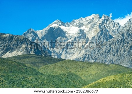 Jade Dragon Snow Mountain is a mountain range in Yunnan Province, China. It is one of the highest mountains in the world, with its highest peak at 5,596 meters (18,373 feet).  Royalty-Free Stock Photo #2382086699