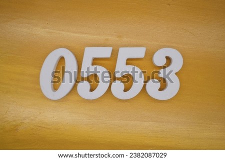 The golden yellow painted wood panel for the background, number 0553, is made from white painted wood.