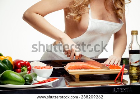 beautiful blonde at the table, preparing a meal