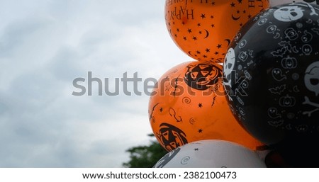 Black, white and orange balloons decoration for Halloween, a place for text