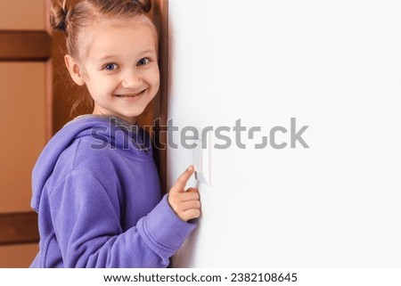 Turn off Light. Child Girl Switch off the Light to Save Energy. White Wall Background. Copy Space. Teaching Children Saving Energy. Eco friendly Lifestyle. Royalty-Free Stock Photo #2382108645