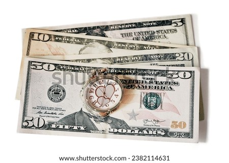 Concept time is money dollars banknotes on a white background isolated rising and falling dollar with a clock with hearts close-up. Royalty-Free Stock Photo #2382114631