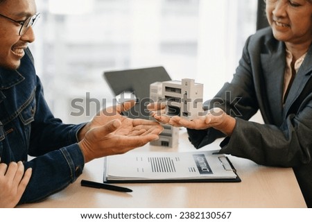 Customers who choose to buy a condominium room and a bank approve a loan for their purchase. Condominium and house loan interest rate from bank concept at office
 Royalty-Free Stock Photo #2382130567