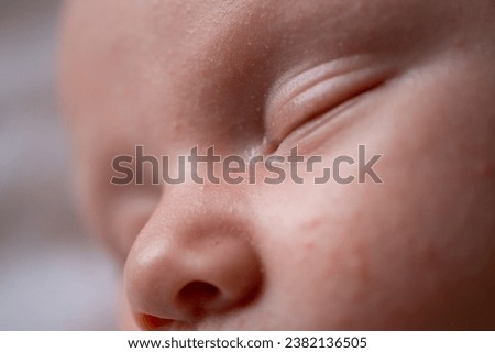 Macro shot of an infant's sleeping face. Beautiful picture of a caucasian baby's face while he is asleep. The perfect healthy face of an infant. Family and parenthood concept. 