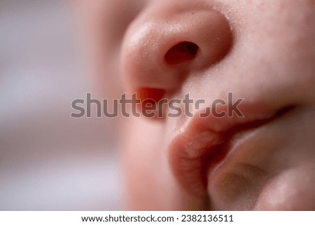 Macro shot of an infant's sleeping face. Beautiful picture of a caucasian baby's mouth while he is asleep. The perfect healthy face of an infant. Family and parenthood concept. 