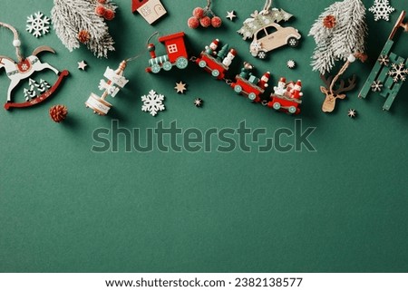 Vintage Christmas frame. Top view wooden painted toys and decorations on green background.