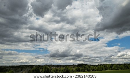 Above the Clouds. High Angle View of Beautiful Sky with Colourful Clouds over Luton city of England UK. Footage Captured with Drone's Camera During Mostly Cloudy Day over England UK Royalty-Free Stock Photo #2382140103
