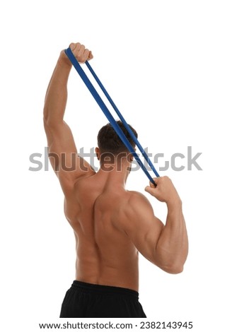 Young man exercising with elastic resistance band on white background, back view