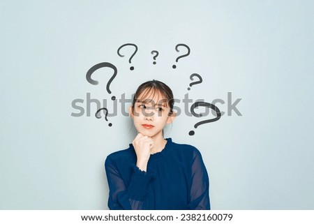 Facial expression of a thoughtful young Asian woman. Royalty-Free Stock Photo #2382160079