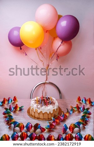 Birthday cake with colorful balloons