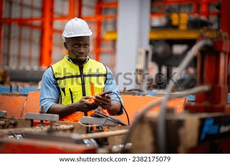 Young male engineer in metal sheet factory Responsible work is being inspected at the actual work site. Work professionally and happily