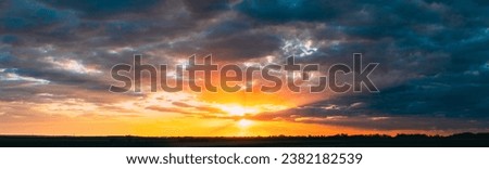 Panoramic View On Amazing Sunset Sunrise Morning Sky With Dark Rain Clouds. Morning Summer Time. Sunrise Sun Shining Through Clouds. Morning Summer Time. Sunrise Sun Shining Above Landscape. Royalty-Free Stock Photo #2382182539