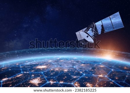 Telecommunication satellite providing global internet network and high speed data communication above Europe. Satellite in space, low Earth orbit. Worldwide data communication technology. Royalty-Free Stock Photo #2382185225