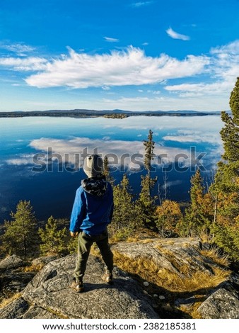 A little boy on the White Sea coast on a sunny day. Karelia. Russia 2021