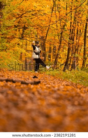 woman looking for mushrooms in autumn forest