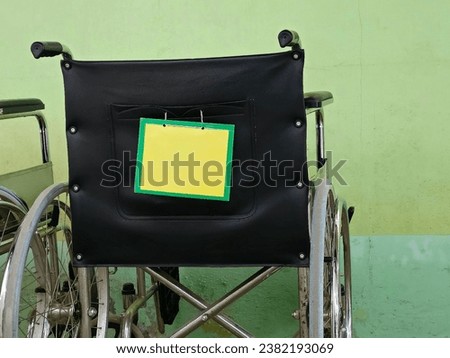 Dirty wheelchair in hospital with blank sign On the wall of the room, green and dirty