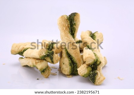 Top shot of Methi Twisted Khari with green filling on white background. High Resolution