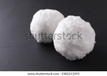 Balls of clean cotton wool on grey background, closeup. Space for text