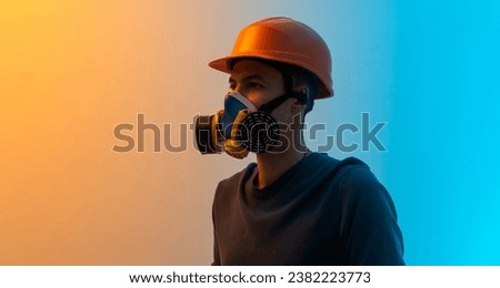 a man in a mask with a filter and a helmet color background Royalty-Free Stock Photo #2382223773
