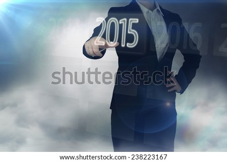 2015 on interface against businesswoman in suit pointing finger