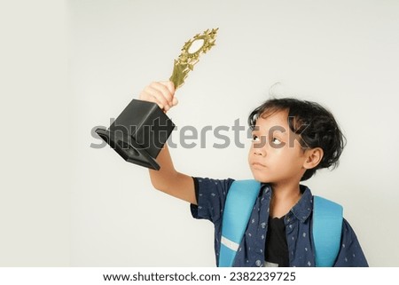 Boy holding school championship trophy on white background, isolated