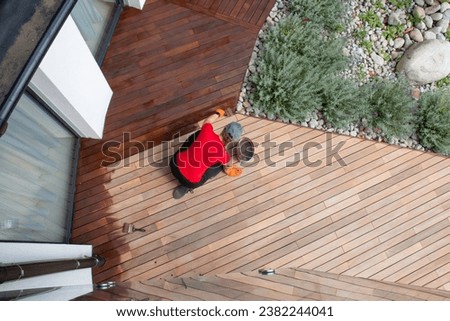 Top view exterior wood deck house terrace maintenance, worker painting wooden floor, before and after effect Royalty-Free Stock Photo #2382244041