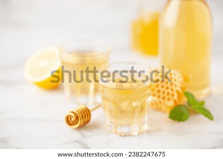 Mead, alcoholic honey strong drink. Alcoholic tincture with honey and lemon Royalty-Free Stock Photo #2382247675