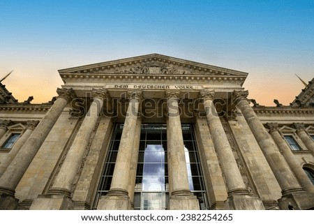 View of the German Parliament, The Reichstag Building (Bundestag) in Berlin at sunset. The description says "Dem Deutschen Volke". Royalty-Free Stock Photo #2382254265