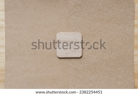 isolated rounded corner square on plain brown paper card with decor finish on wood