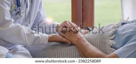 close up, an elderly male patient holds hands with a nurse who comes to take care of and help encourage each other. Royalty-Free Stock Photo #2382258089