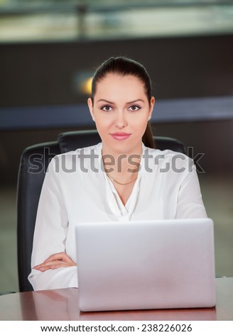 Young pretty business woman with laptop in the office