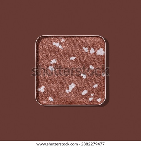 Top view eye shadow glitter brown swatch with shadow, monochrome minimal style photo, sparkling eyeshadow, colored shiny powder for festive makeup, square shape metal pack, beauty cosmetics card