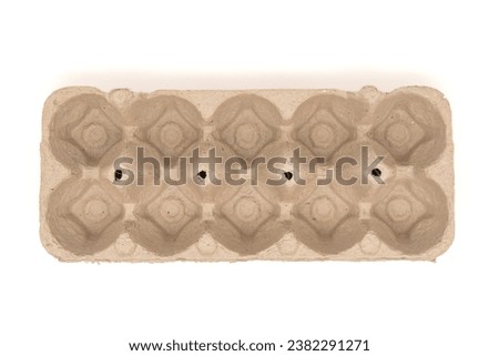 Empty egg-container for ten eggs, isolated on white with copy space. Carton pack, egg box for packaging. Top view or flat lay. Royalty-Free Stock Photo #2382291271