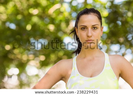 Focused athletic brunette in the park on a sunny day